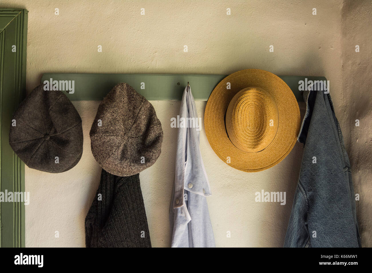 Vintage hats and coats hanging on coat hooks in the entrance of a 1800s  cottage Stock Photo - Alamy