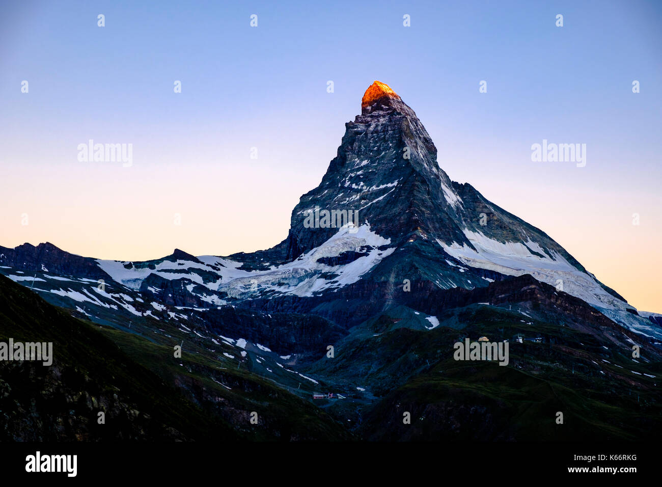 The East and North Face of the Matterhorn, Monte Cervino, with the sunlight touching the summit at sunrise Stock Photo