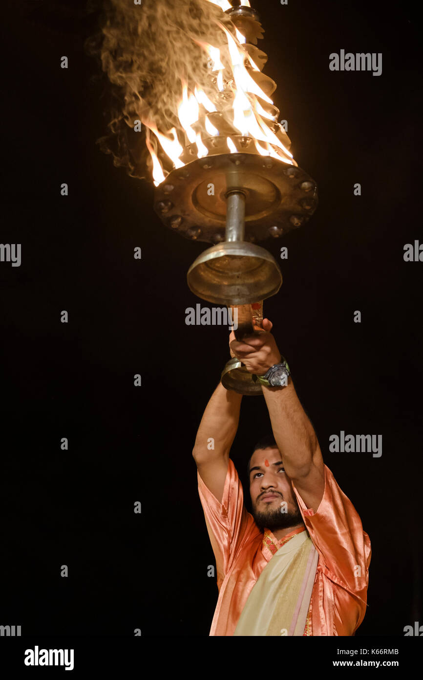 VARANASI, INDIA - CIRCA NOVEMBER 2016:  Young pandit performing the Ganga Aarti ceremony at the  Dasaswamedh Ghat in Varanasi. The Aarti is a powerful Stock Photo