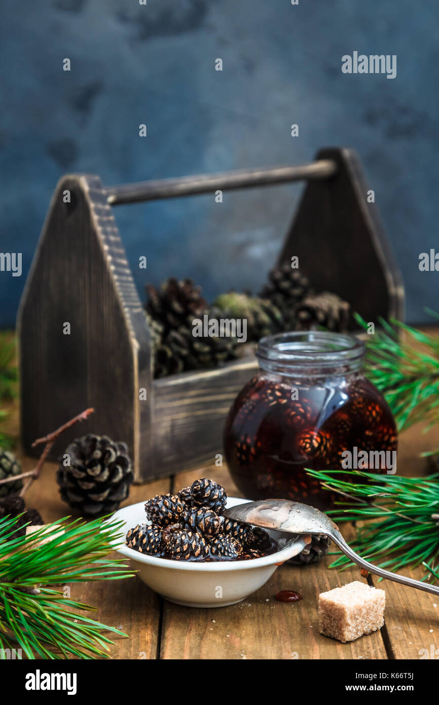 Pine cones jam in jar with wooden box Stock Photo Alamy