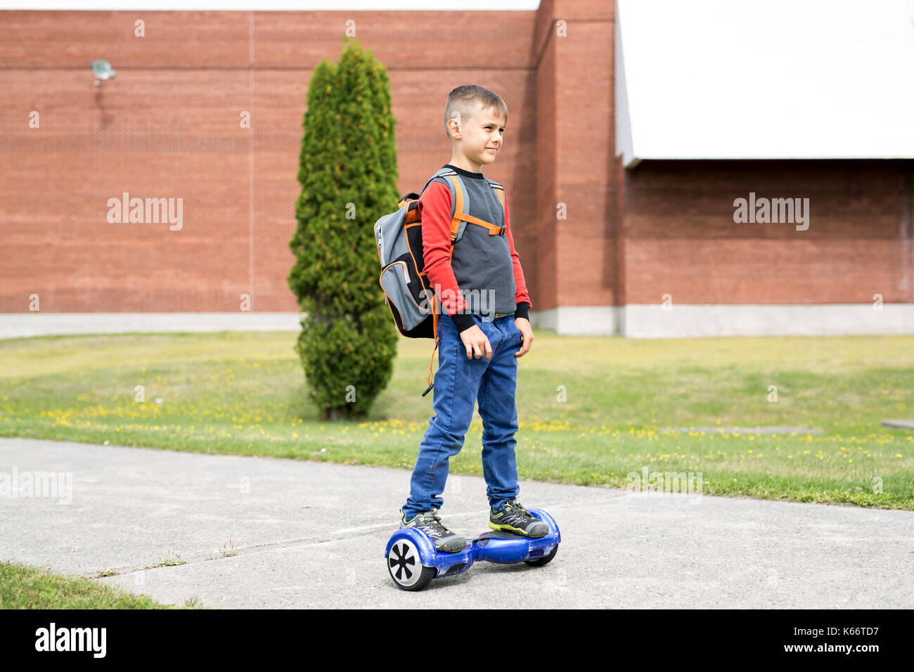 Little boy riding electric vehicle. He's good at it. He likes it. Stock Photo