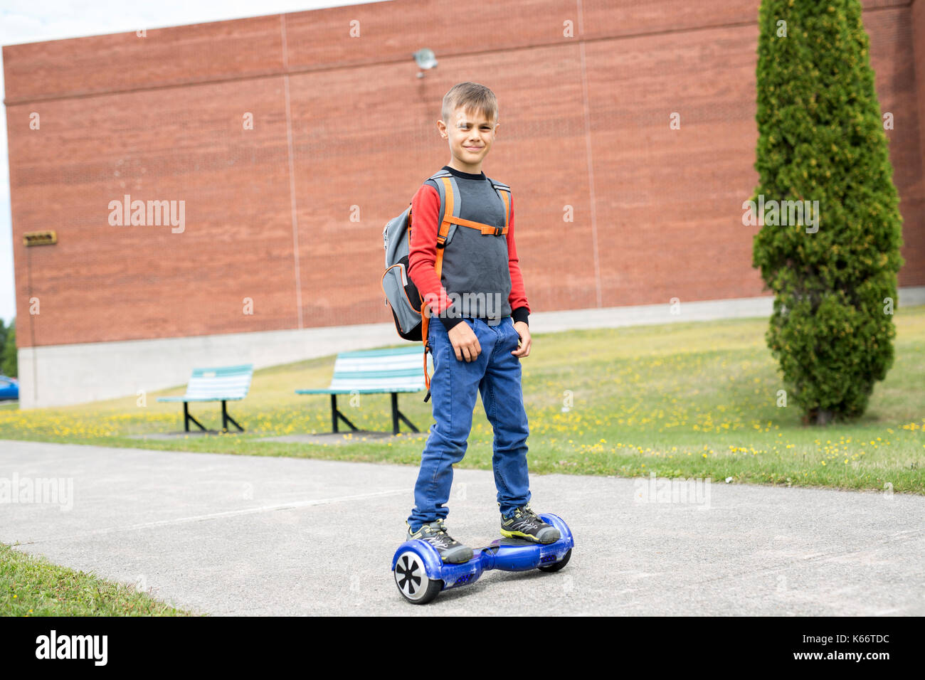 Little boy riding electric vehicle. He's good at it. He likes it. Stock Photo