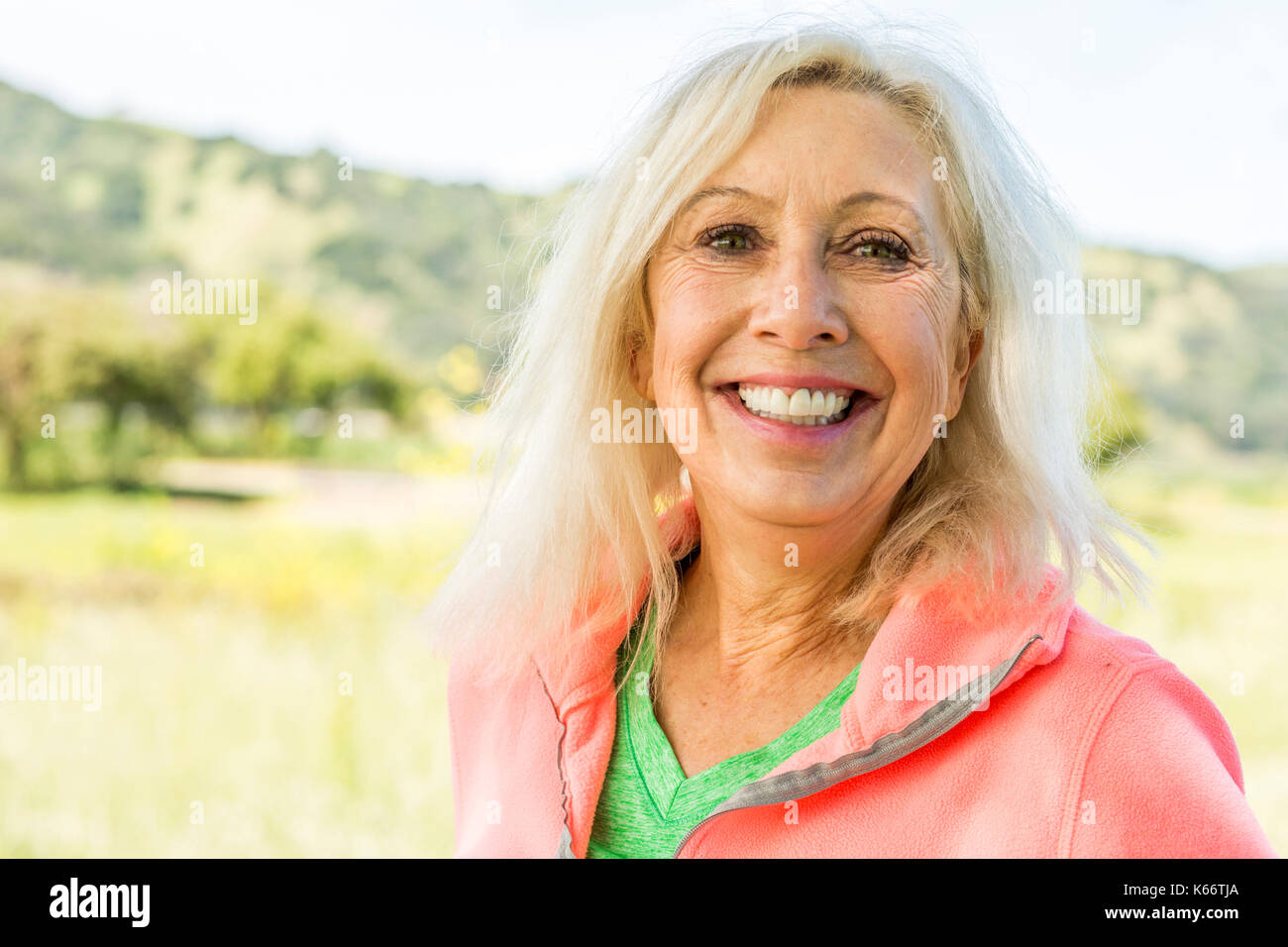 Portrait of smiling Older Caucasian woman outdoors Stock Photo