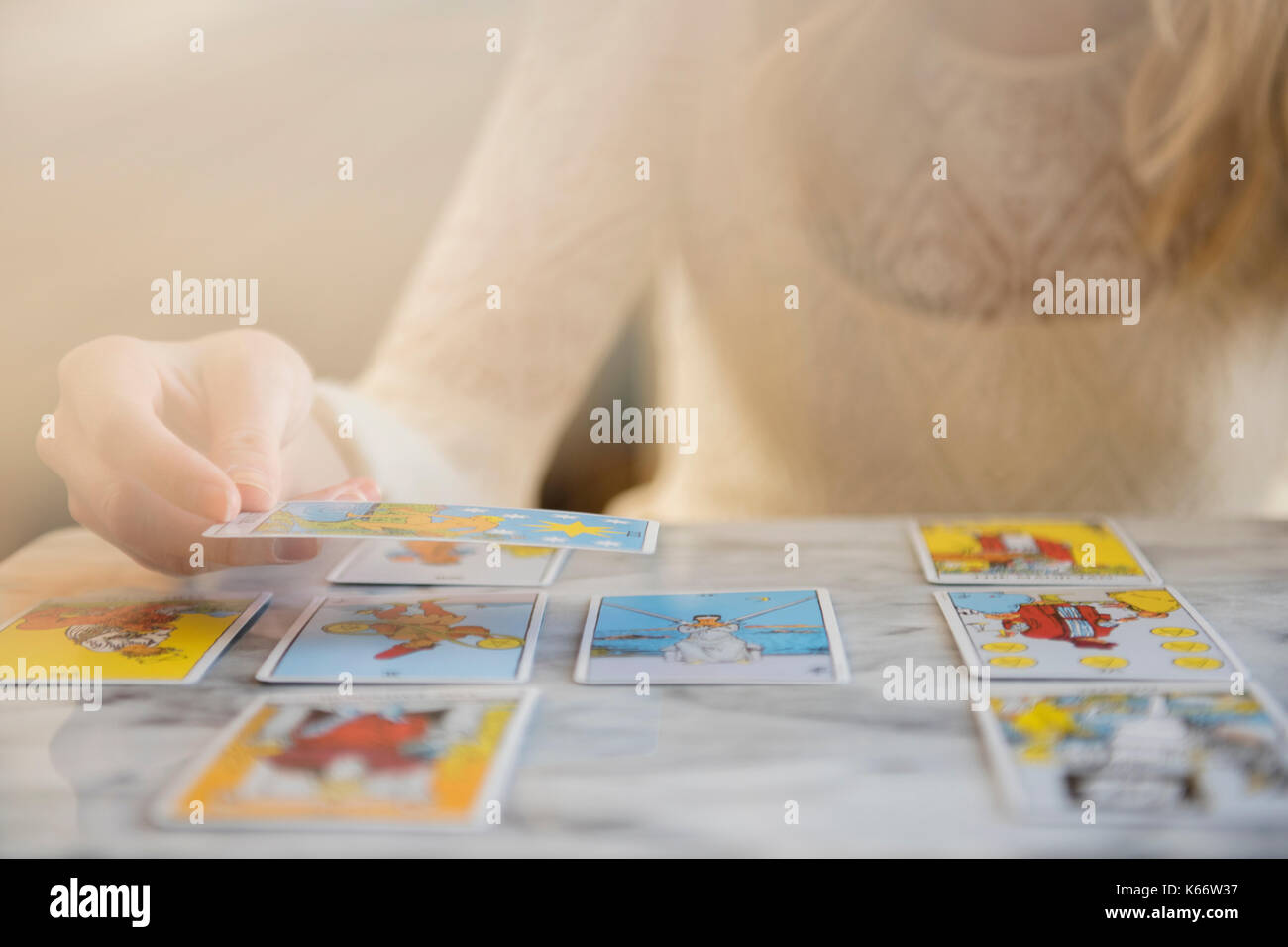 Caucasian woman using tarot cards Stock Photo