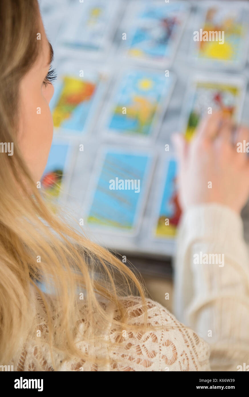 Caucasian woman using tarot cards Stock Photo