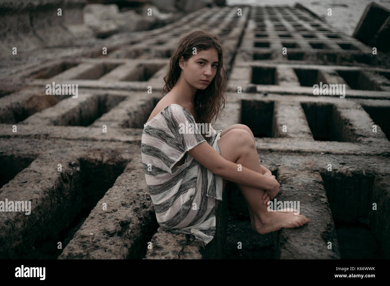 Portrait of Caucasian teenage girl sitting on structure Stock Photo - Alamy