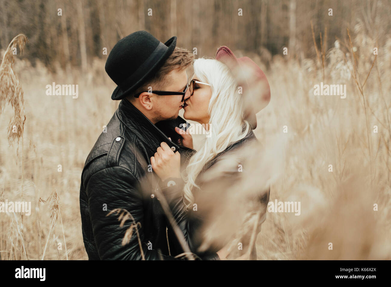 Middle Eastern couple kissing in field Stock Photo