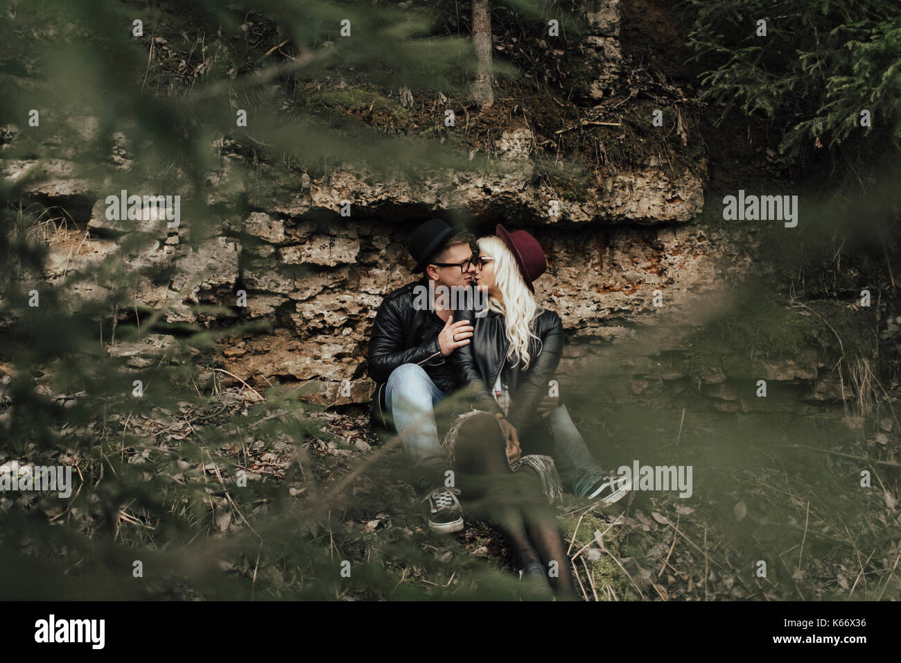 Affectionate Middle Eastern couple kissing near rocks Stock Photo
