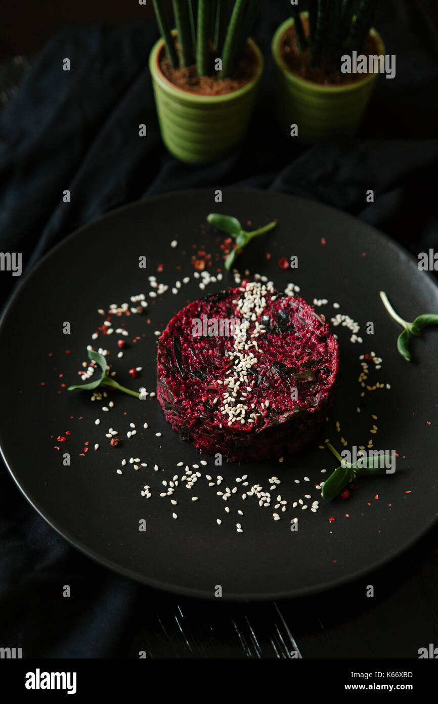 Sesame seeds and garnish on red food on plate Stock Photo Alamy