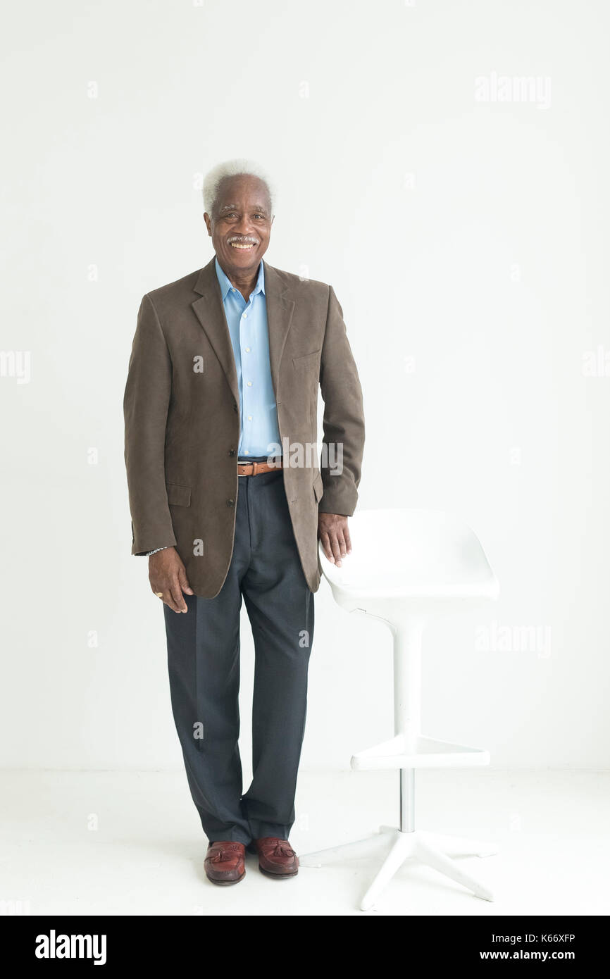Portrait of older Black man leaning on store Stock Photo - Alamy