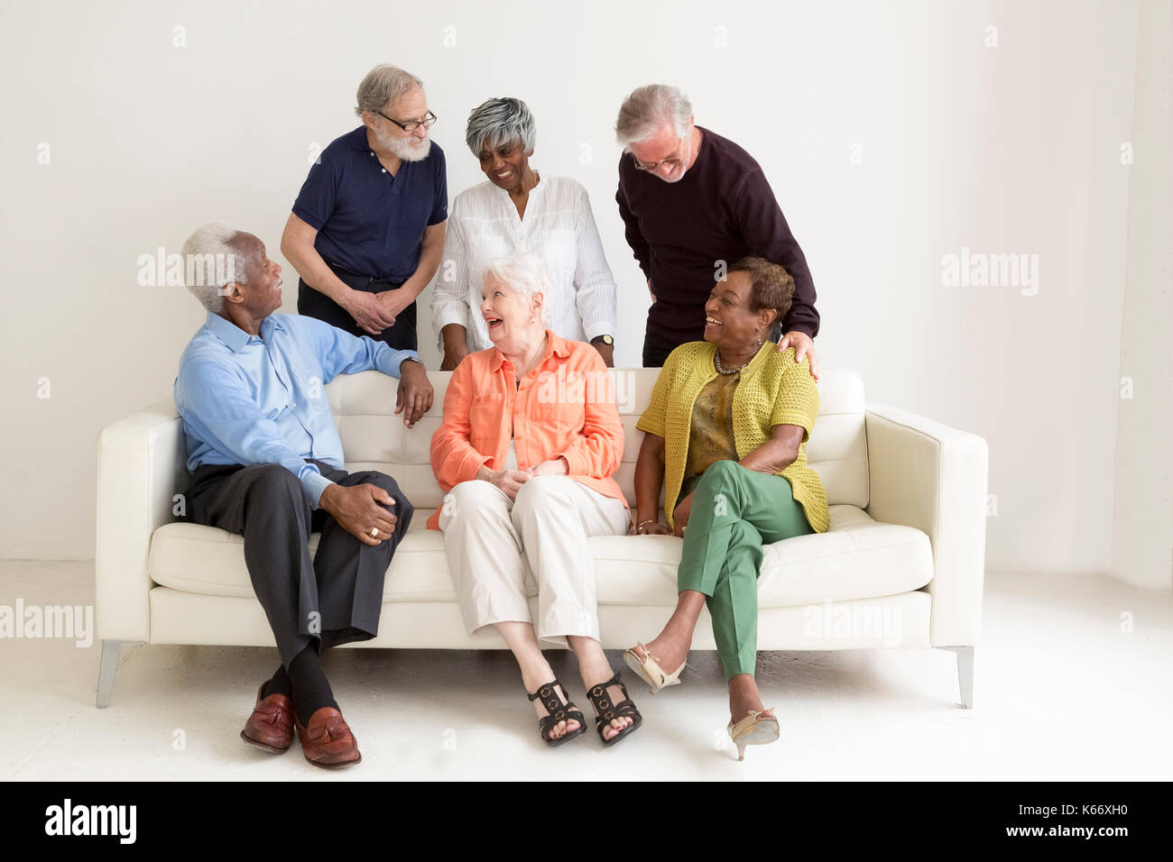 Older people laughing on sofa Stock Photo Alamy