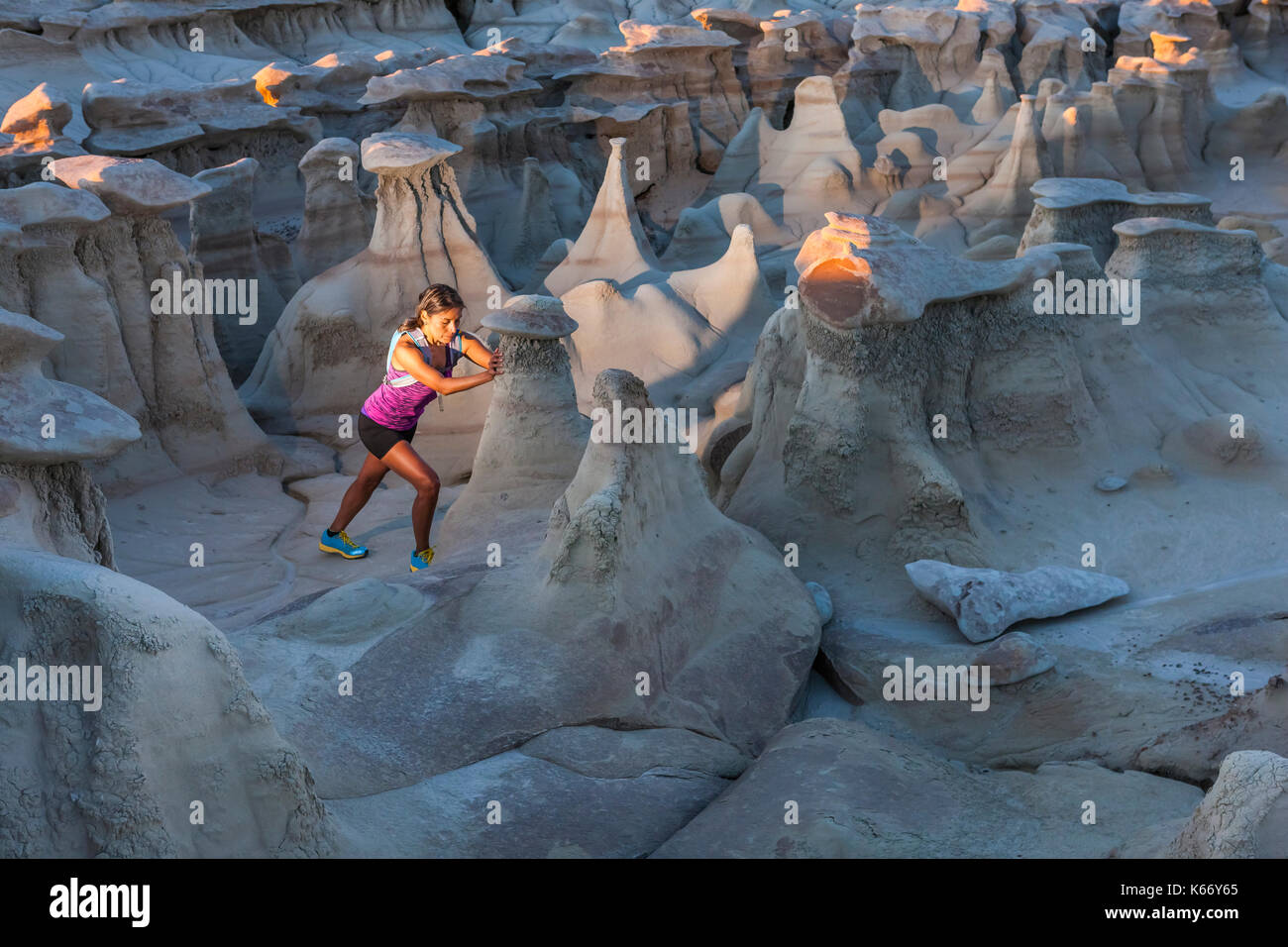 Native American woman stretching in desert Stock Photo