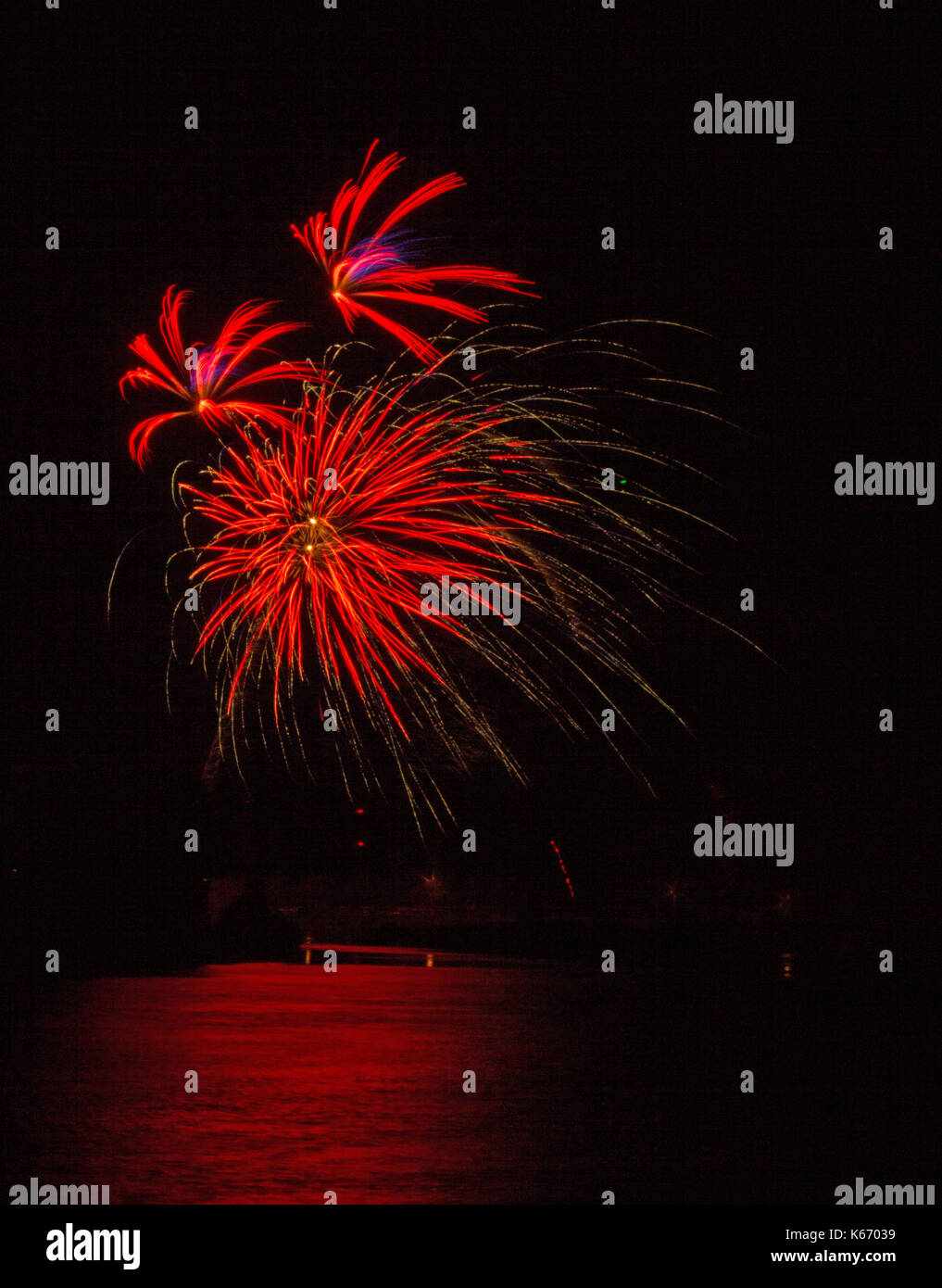 Fireworks along the Snake River on the 4th of July in Idaho Falls, Idaho.  The light is reflected in the river. Stock Photo