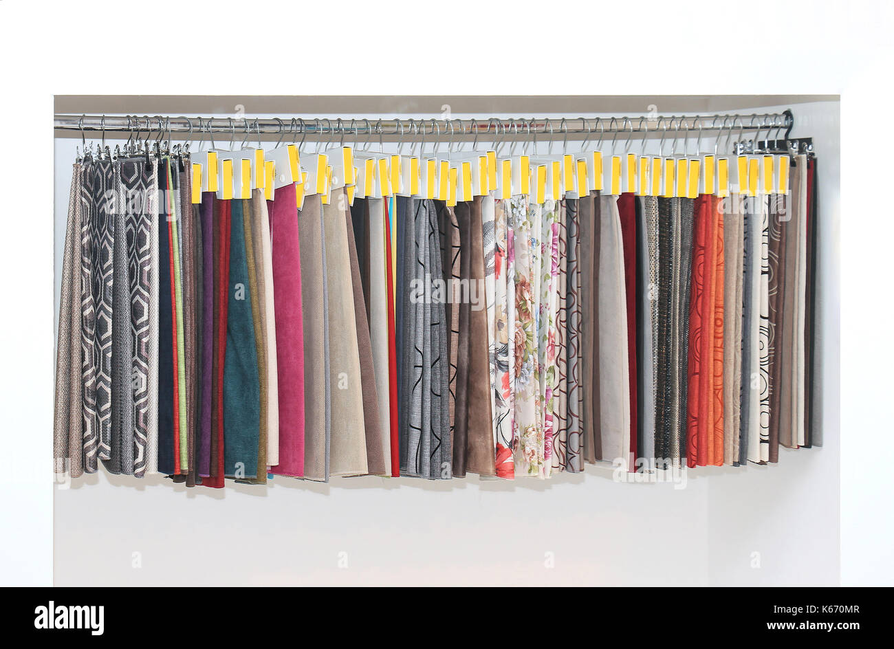 Furniture upholstery pattern samples on hangers on the wall Stock Photo -  Alamy