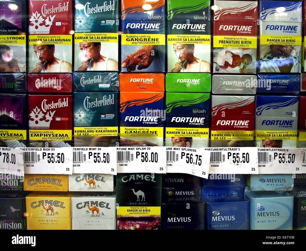 ANTIPOLO CITY, PHILIPPINES - SEPTEMBER 10, 2017: Assorted packs of cigarette with warning labels on display at a grocery store. Stock Photo