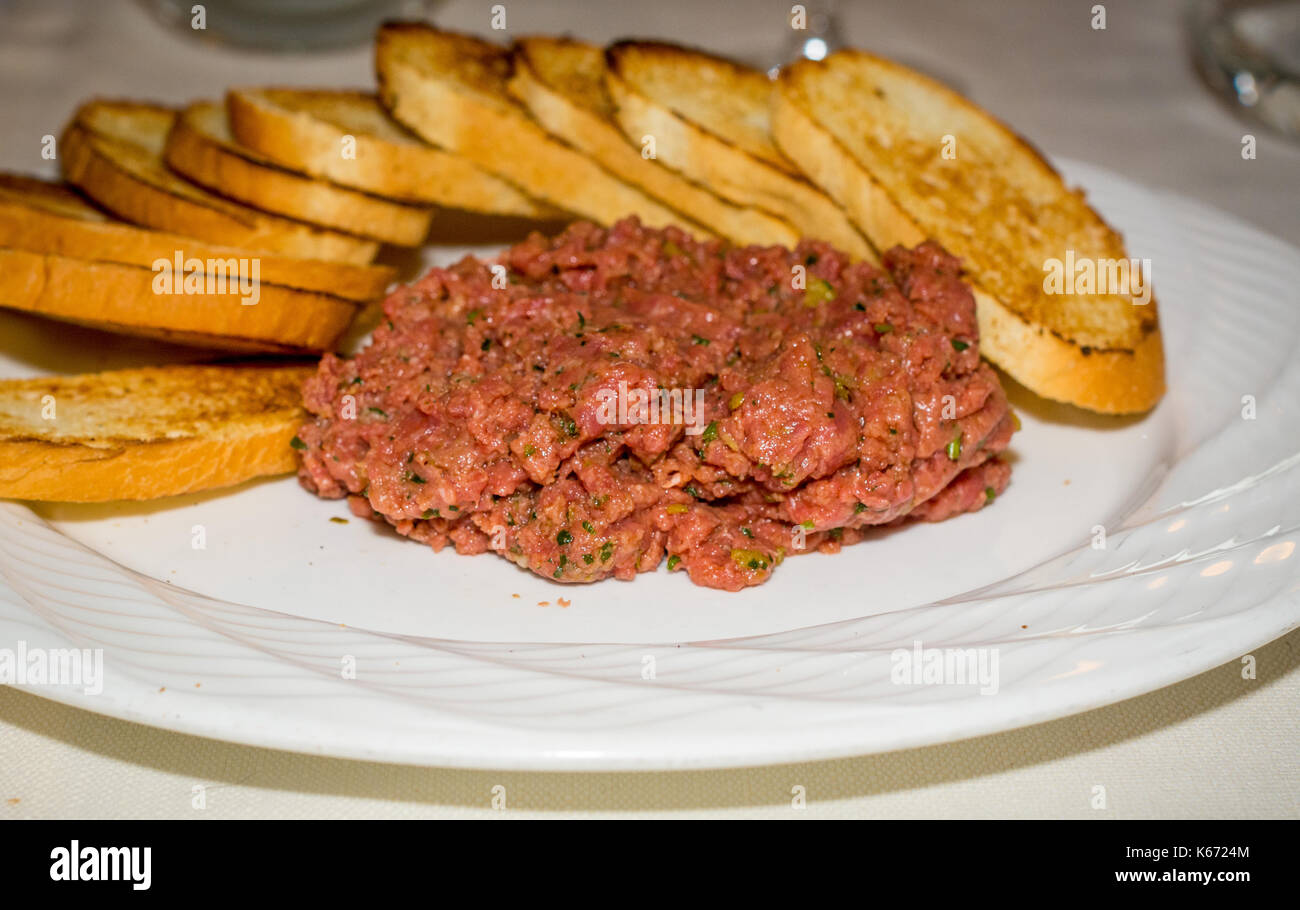 beef tartare with slices of toasted bread. steak tartare Stock Photo