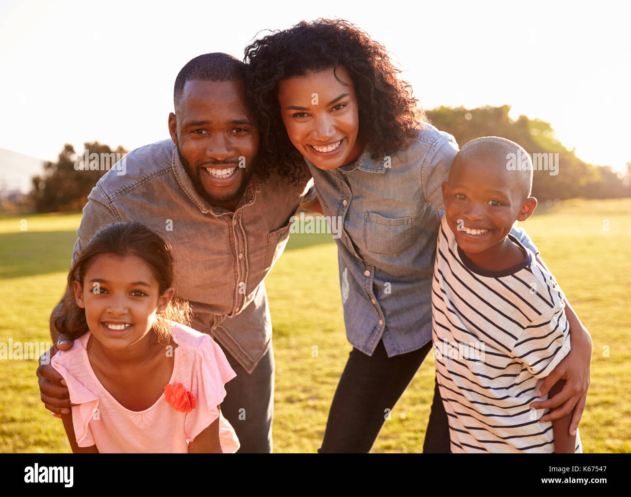 Portrait of smiling black family looking to camera outdoors Stock Photo ...