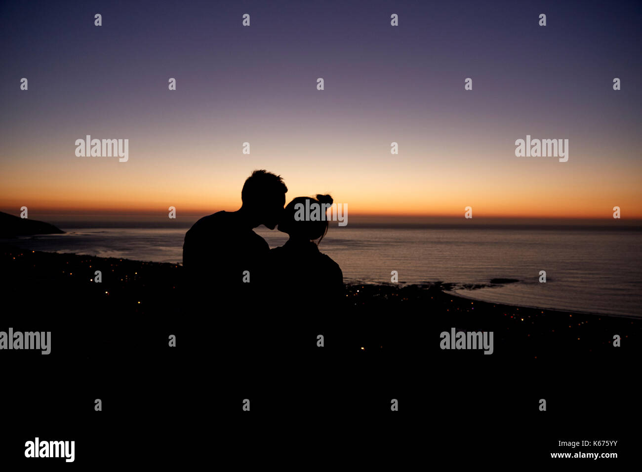 Couple kissing by the sea at sunset on a beach, silhouette Stock Photo ...