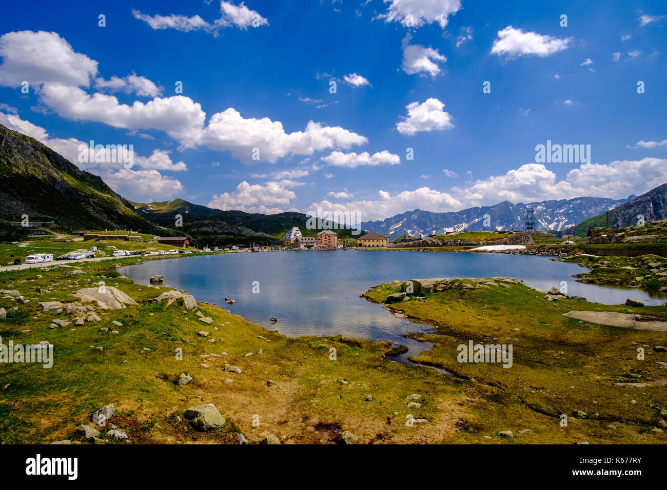 Landscape with the buildings of the small village and a lake on top of Passo del San Gottardo, Gotthard Pass Stock Photo