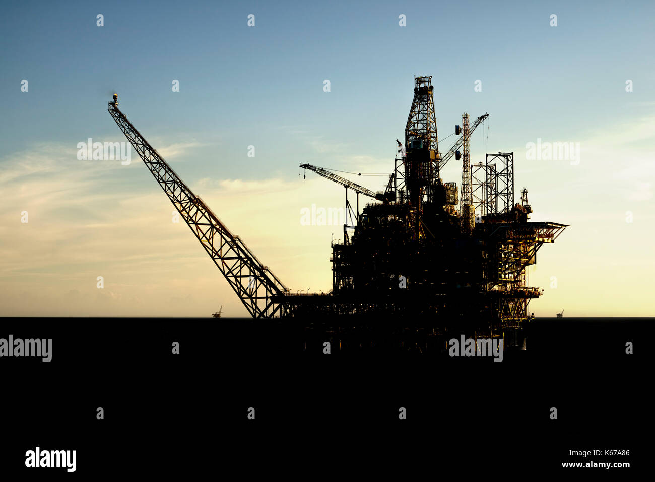Silhouette of an offshore rig Stock Photo