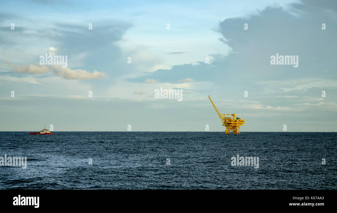 Offshore oil rig and supply boat Stock Photo