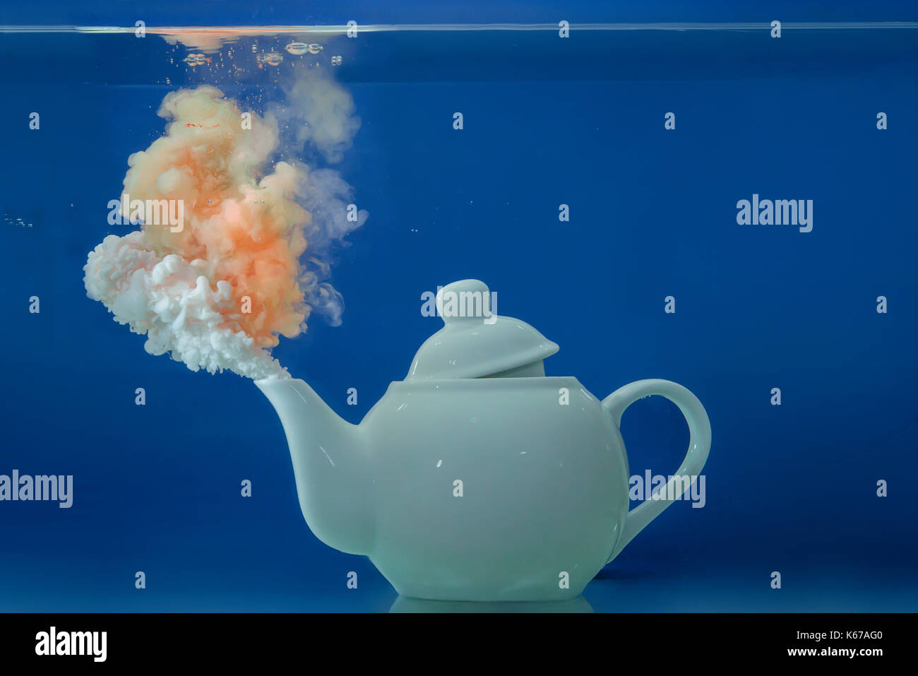 Teapot underwater with conceptual steam coming out of spout Stock Photo