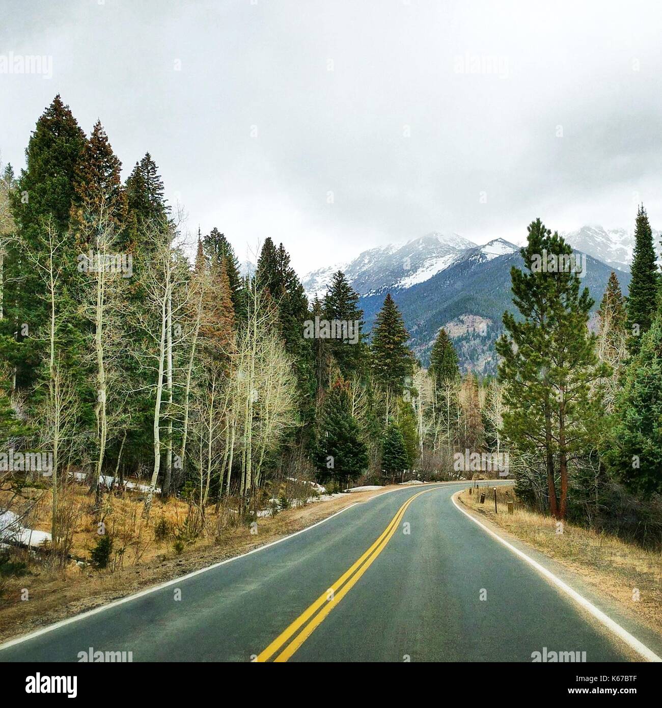 Empty road through the Rocky Mountains, Colorado, United States Stock Photo