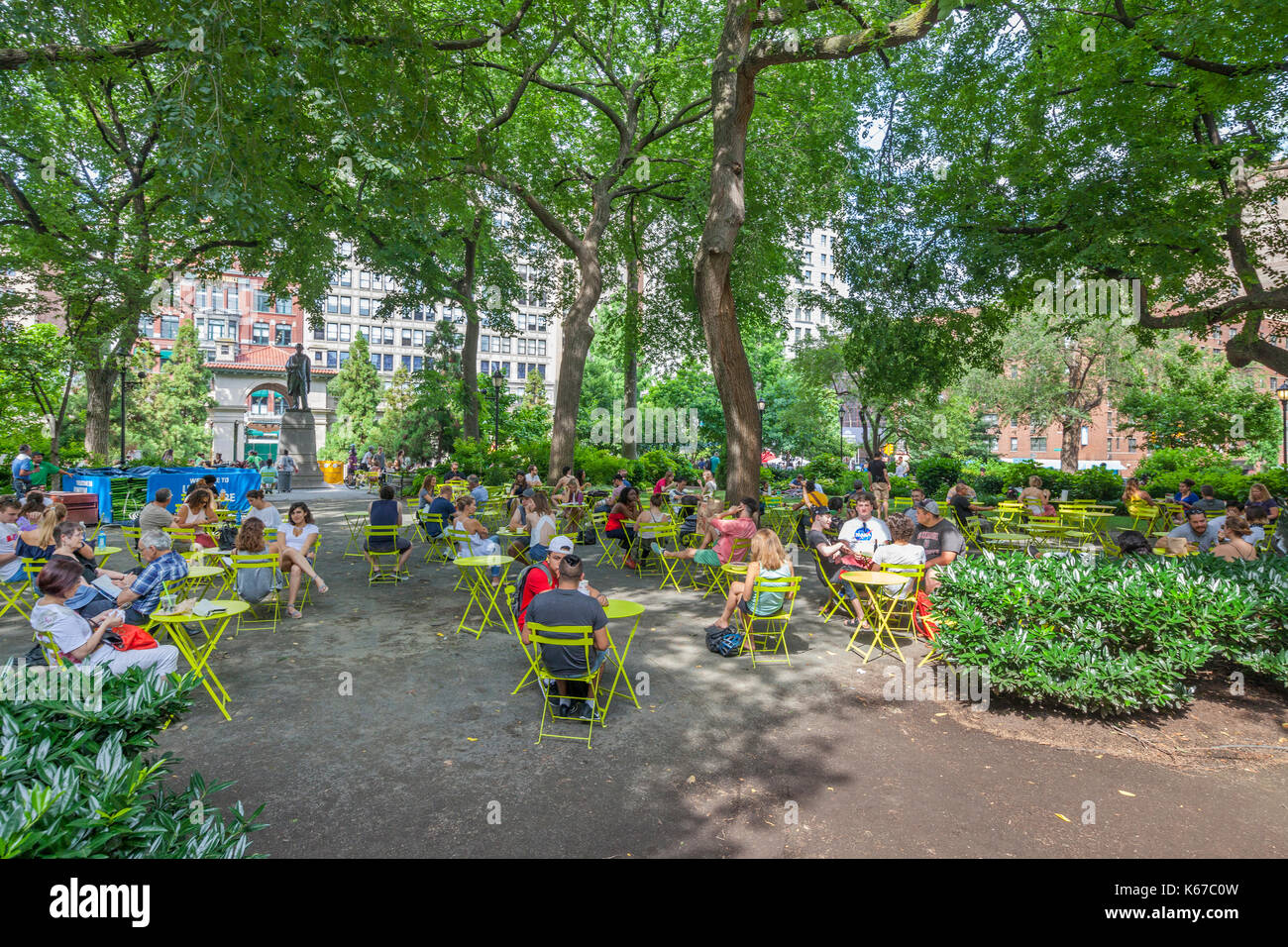 People enjoying leisure time in Union Square, New York near the Abraham Lincoln Monument. Stock Photo