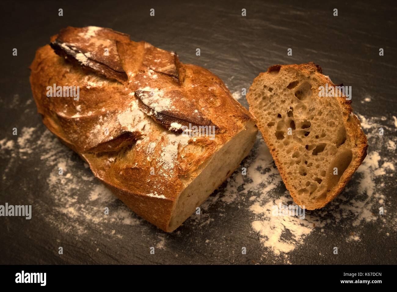 Loaf of bread with a slice Stock Photo