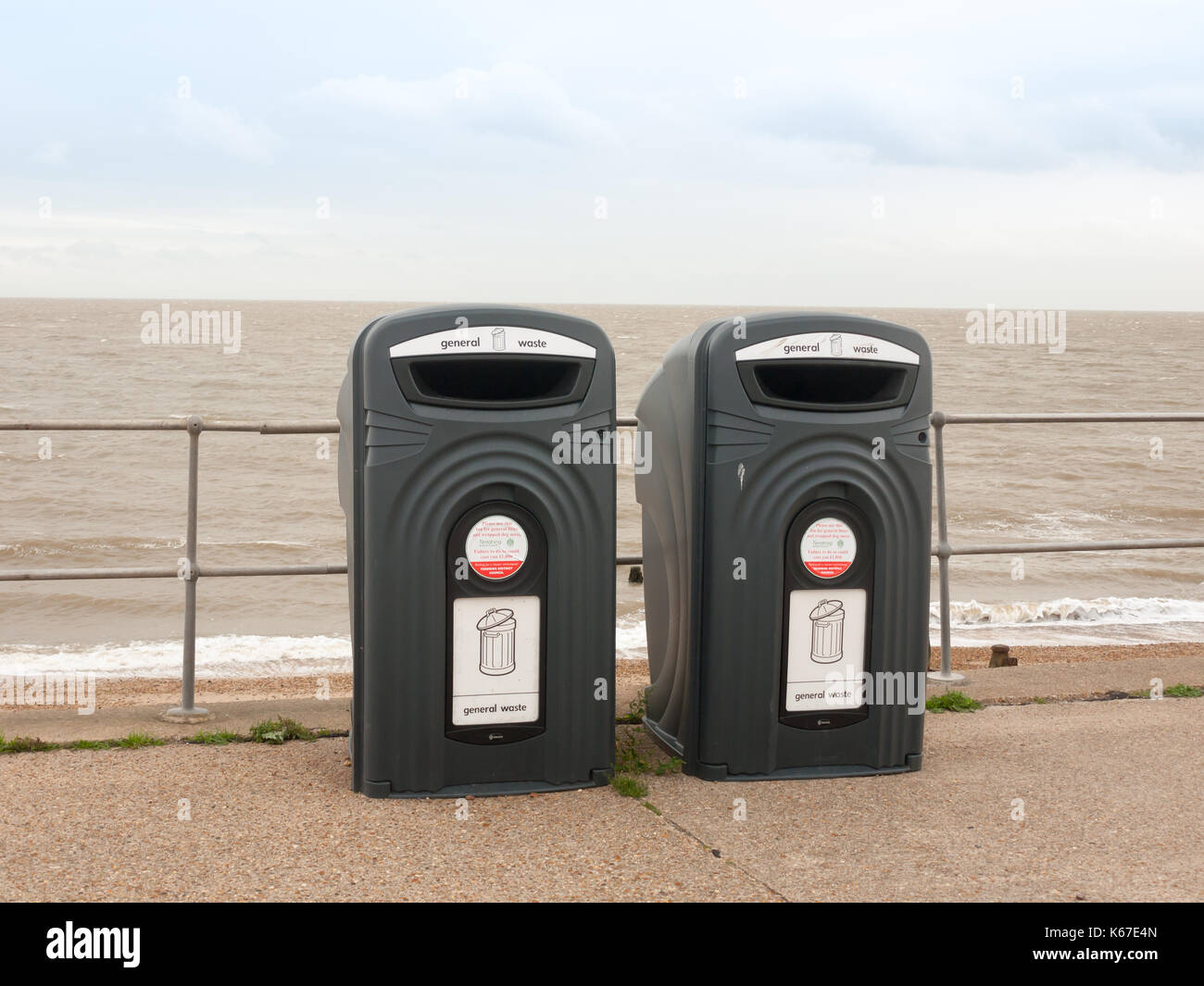 two black recycling bins on the sea front beach for glass; England; UK