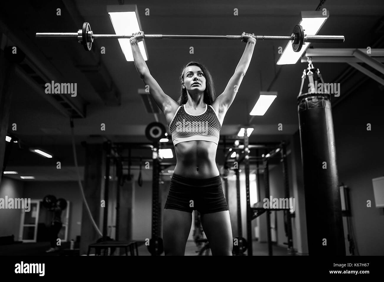 woman lifting a weight crossfit in the gym. Fitness woman deadlift barbell. Stock Photo
