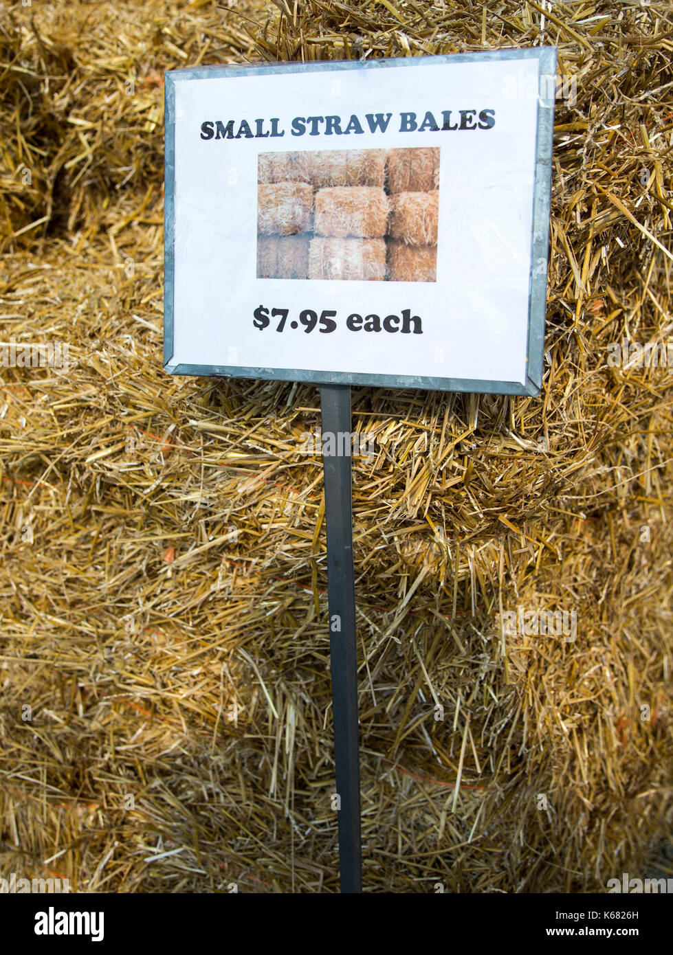 Bales of hay for sale at a farm stand Stock Photo