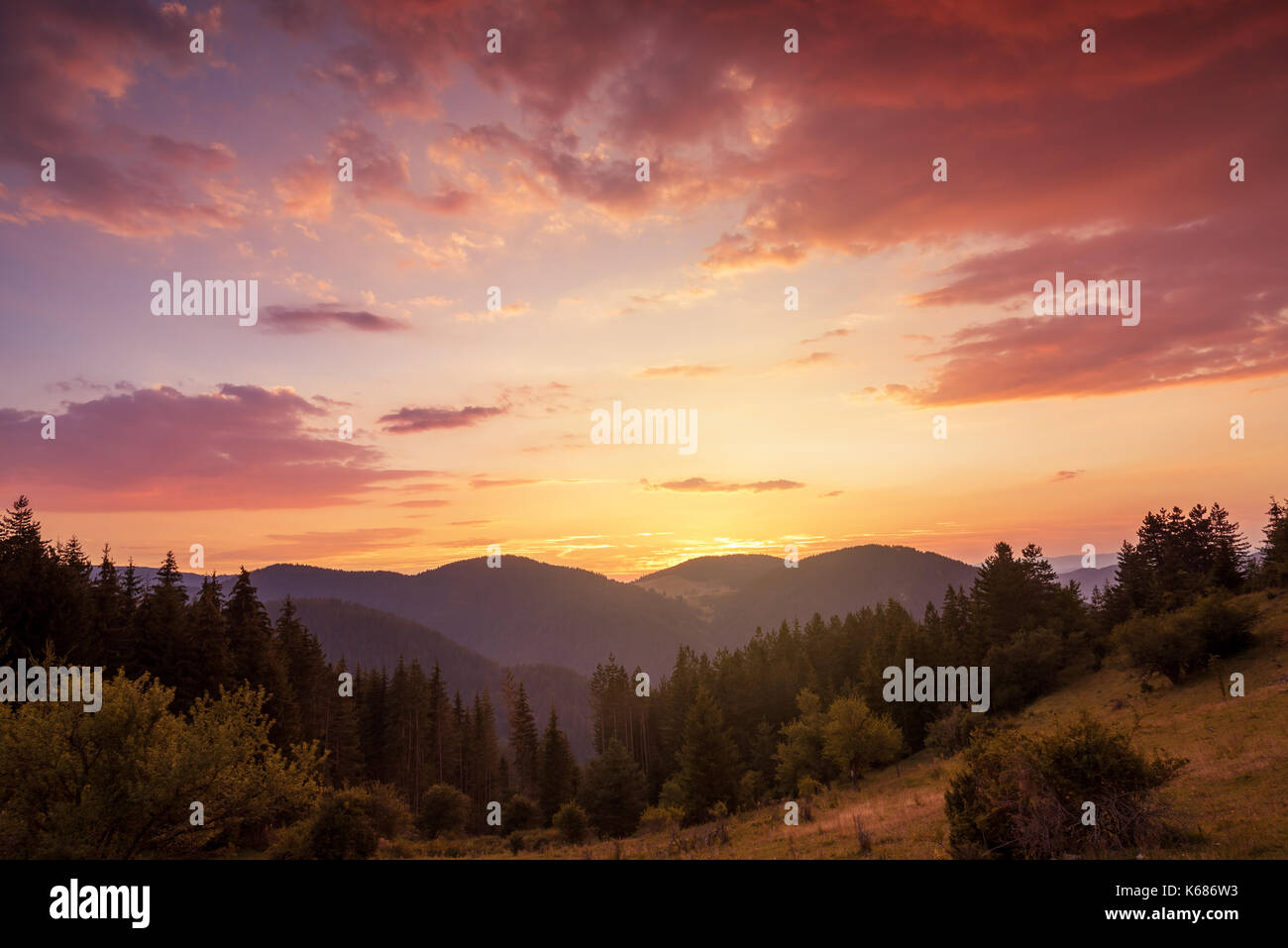 Amazing mountain landscape with colorful vivid sunset on the cloudy sky ...