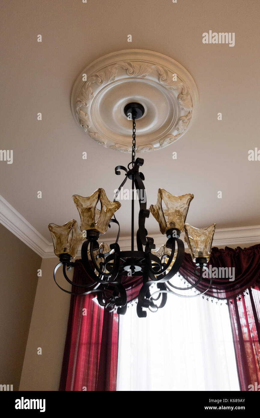 Iron Chandelier Stock Photos Images Alamy A Custom Made Golden Glass And Wrought Iron Chandelier Hanging By Majestic Red Curtains