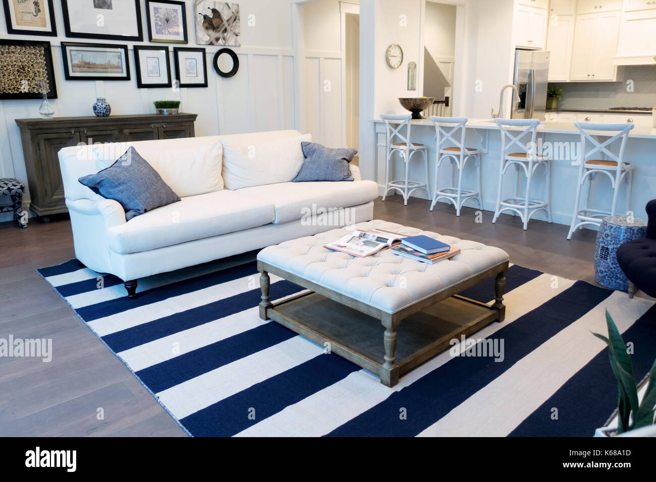 An Open Living Room Looking At An Open Kitchen Built In Book