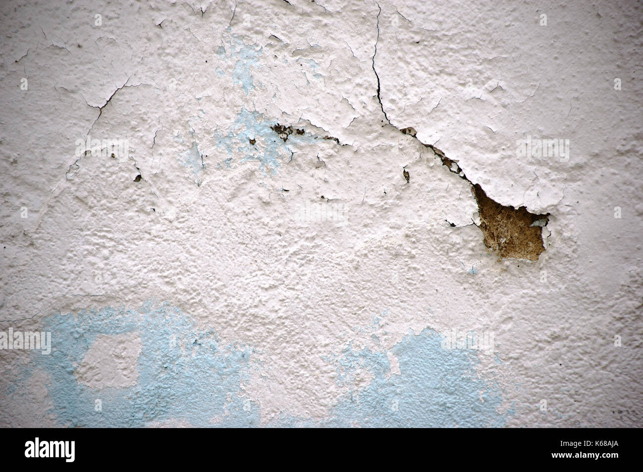 The close up of a wall with a chipped plaster layer. Stock Photo