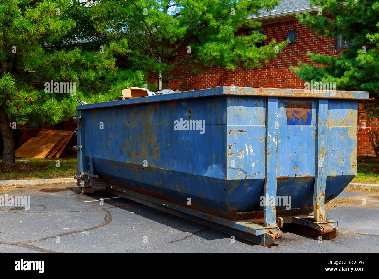 Dumpsters being full with garbage in a city. Dumpsters being full with