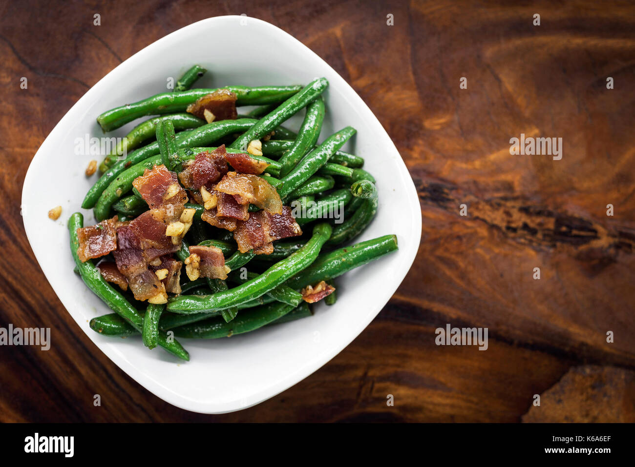 sauteed garlic butter green beans with bacon snack Stock Photo Alamy