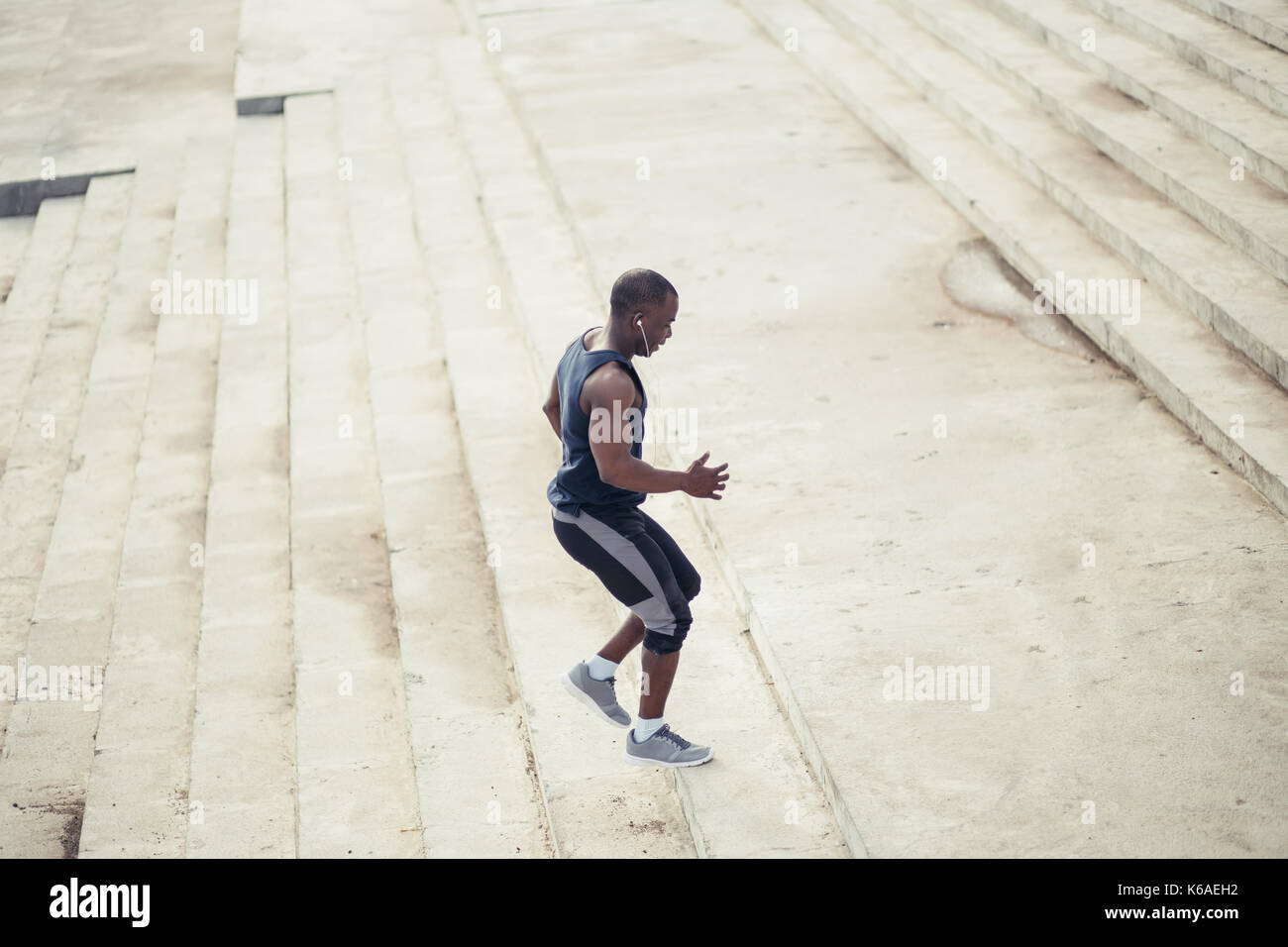 Black man running up stairs hi-res stock photography and images - Alamy