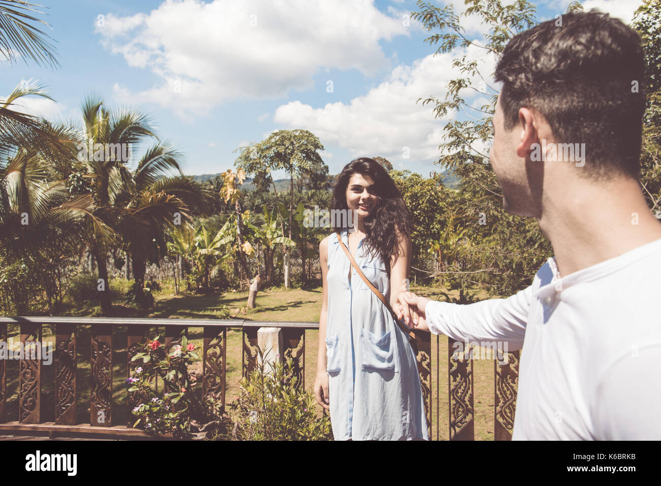 Young Couple On Summer Terrace Or Balcony Woman And Man Over Beautiful View Of Tropical Forest Stock Photo