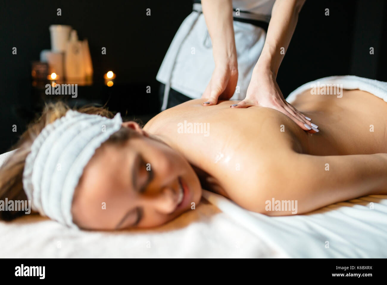 Massage therapist massaging woman Stock Photo