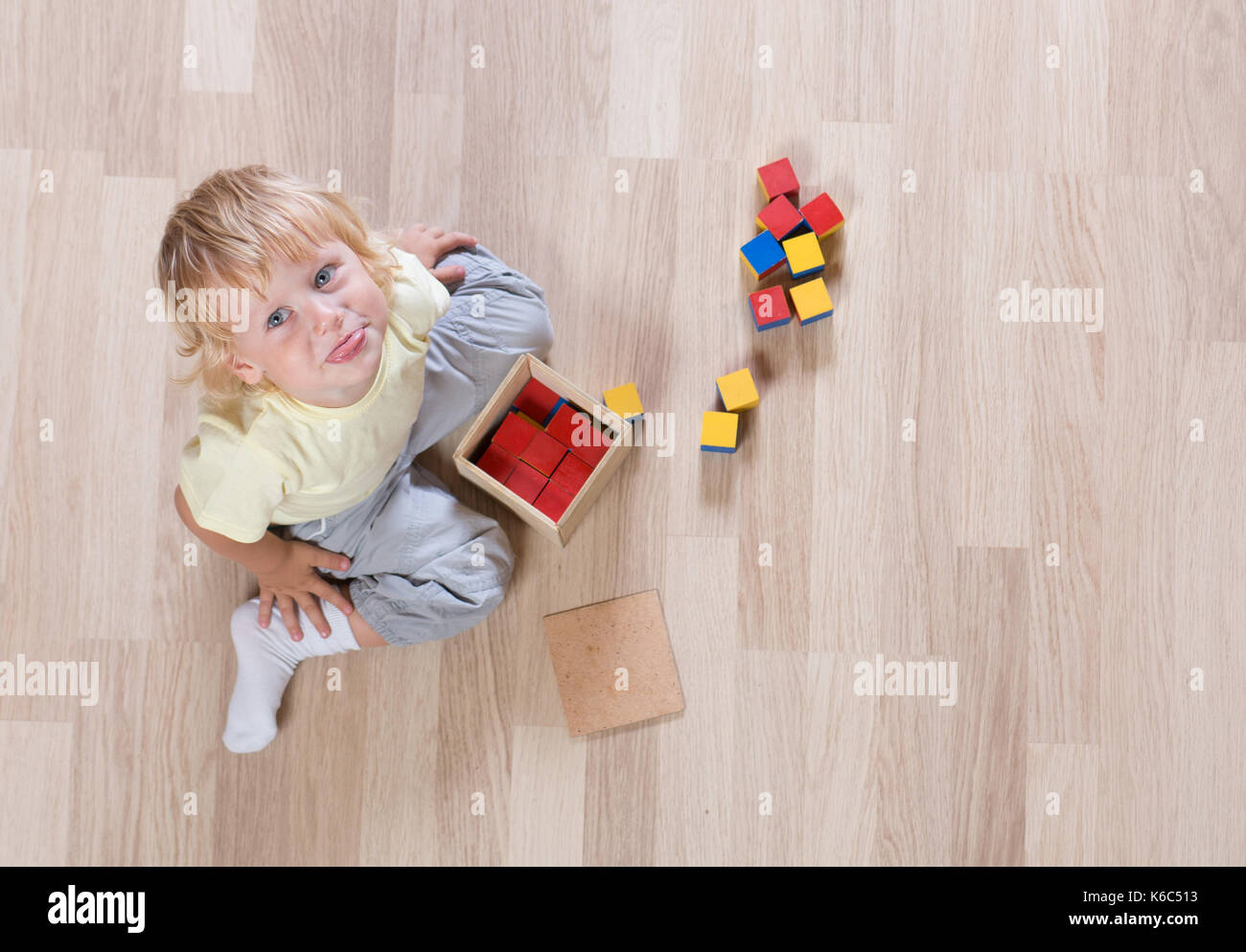 Kid playing with toys on floor top view Stock Photo
