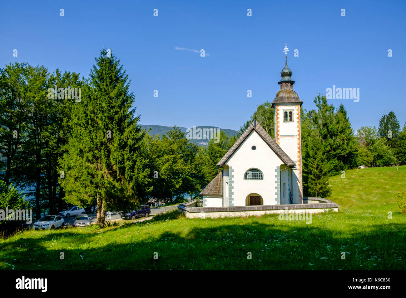 The building of Holy Spirit Church near the village Ribčev Laz at Lake Bohinj, Bohinjsko jezero in Triglav National Park Stock Photo