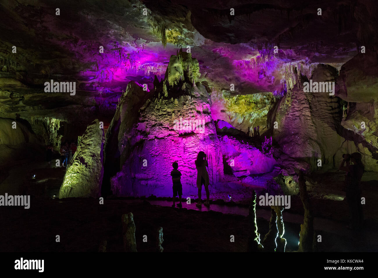 A boy and a girl inside of the Prometheus Cave system, northwest of Kutaisi in caves