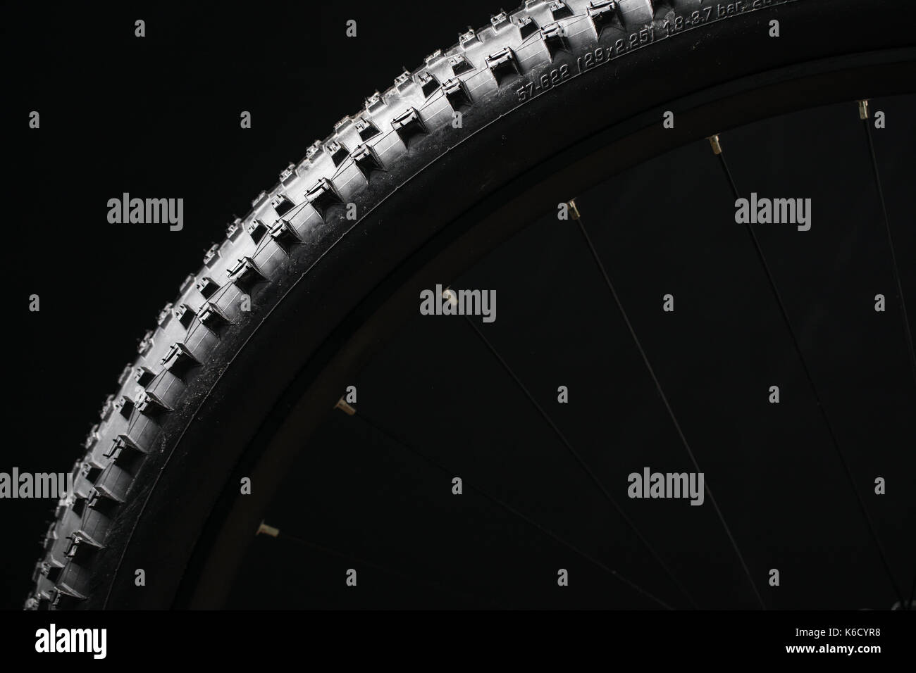 Modern MTB race mountain bike tyre isolated on black background in a studio Stock Photo