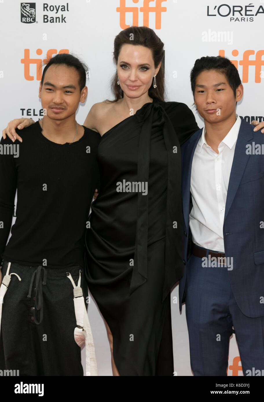 Toronto, Canada. 11th Sep, 2017. Maddox Jolie-Pitt (l-r), Angelina Jolie and Pax Thien Jolie-Pitt attend the premiere of 'First They Killed My Father' during the 42nd Toronto International Film Festival, tiff, at Princess of Wales Theatre in Toronto, Canada, on 11 September 2017. · NO WIRE SERVICE · Photo: Hubert Boesl/dpa/Alamy Live News Stock Photo