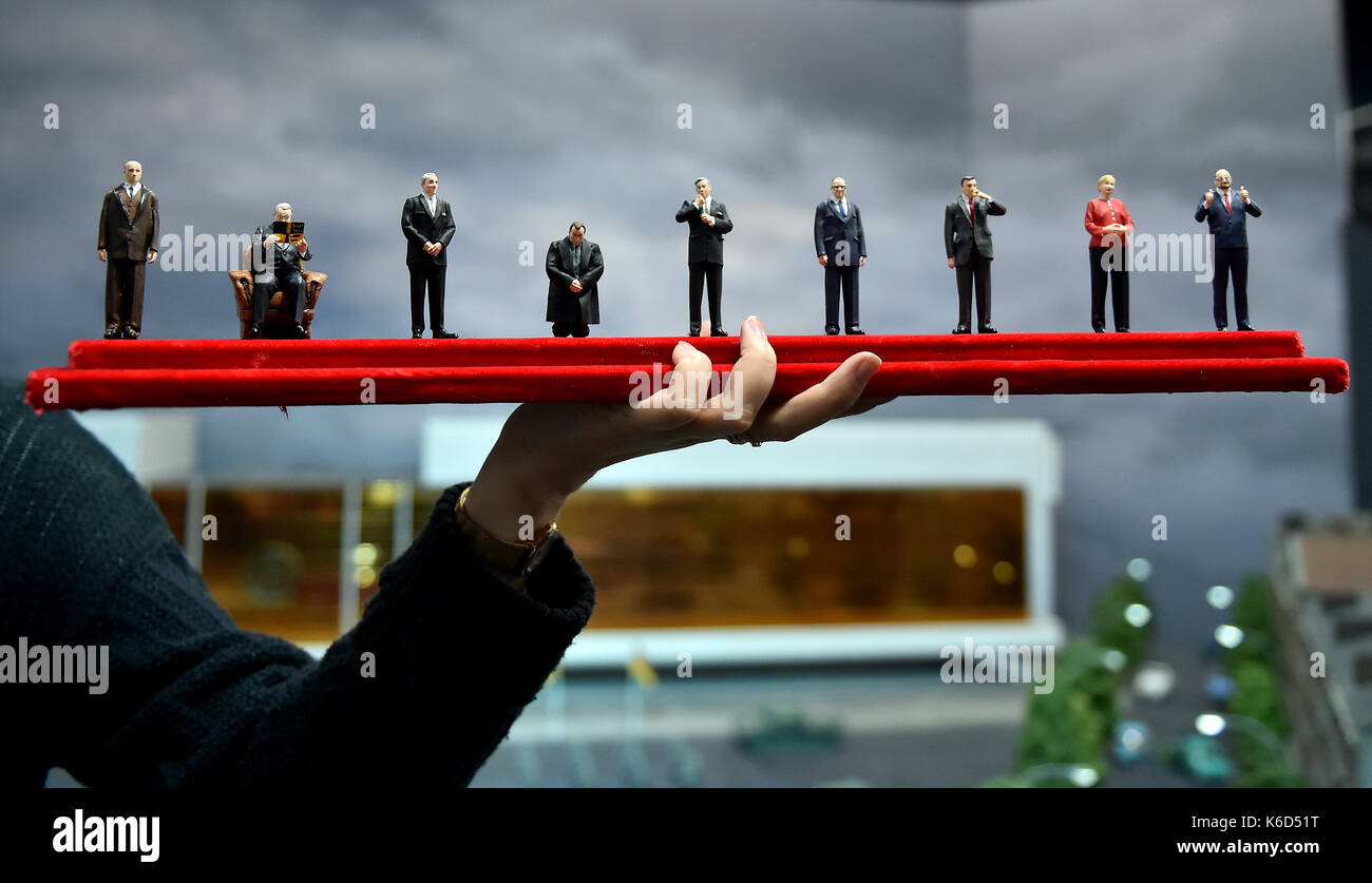 Berlin, Germany. 12th Sep, 2017. Miniature figures of the German Chancellor Konrad Adenauer (L-R), Ludwig Erhard, Kurt Georg Kiesinger, Willy Brandt, Helmut Schmidt, Helmut Kohl, Gerhard Schroeder, Angela Merkel and top candidate Martin Schulz are presented by the Gernal Manager of 'Little BIG City' Anja Nitsch in Berlin, Germany, 12 September 2017. From 12 September - 29 September 2017 the visitors of the Miniature city can vote for their favourite chancellor. Photo: Britta Pedersen/dpa-Zentralbild/ZB/dpa/Alamy Live News Stock Photo