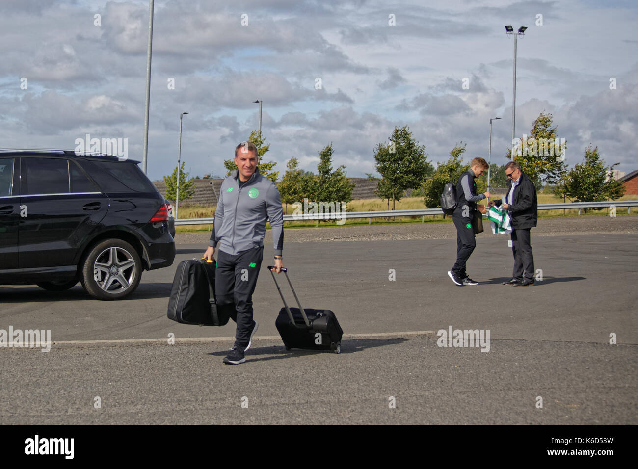 Glasgow, Scotland, UK. 12th Sept, 2017. Paris Saint-Germain Football Club, commonly known as PSG play Glasgow Celtic in the Champions league tonight. Brendan Rodgers arrives as Stewart Armstrong signs a shirt and the Celtic team met  arrives at the stadium to the joy fans there . Credit: gerard ferry/Alamy Live News Stock Photo