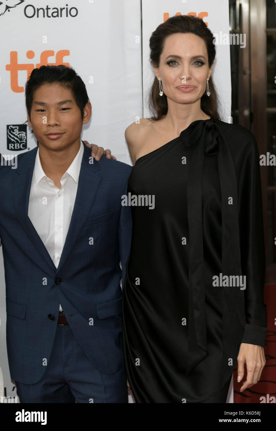 Toronto, Canada. 11th Sep, 2017. Pax Thien Jolie-Pitt (l) and Angelina Jolie attend the premiere of 'First They Killed My Father' during the 42nd Toronto International Film Festival, tiff, at Princess of Wales Theatre in Toronto, Canada, on 11 September 2017. · NO WIRE SERVICE · Photo: Hubert Boesl/dpa/Alamy Live News Stock Photo
