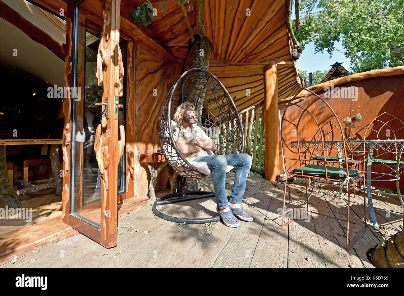 Ditchling Sussex, UK. 12th Sep, 2017. A new tree house has been unveiled at Blackberry Wood campsite near Ditchling in Sussex . The new upmarket tree house called Piggledy has been built by campsite owner Tim Johnson (pictured) and is larger than the original next door tree house called Higgledy . The quirky campsite is well known for having a London bus and an old Wessex helicopter where people can also stay in peaceful surroundings nestled just north of the South Downs National Park Credit: Simon Dack/Alamy Live News Stock Photo